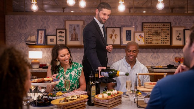 IC, Icon of the Seas, Server pouring champagne for guests at Celebration Table in AquaDome, fun, VIP experience,