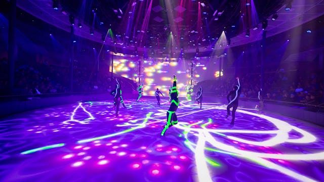 IC, Icon of the Seas, Ice Skaters performing at Absolute Zero while crowd watches, entertainment, performance, performers, show, lights, purple and green colors, day-glo green, arena,