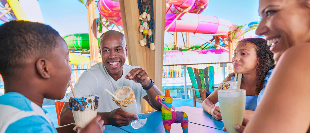 Family enjoying milkshakes at Basecamp onboard Icon of the Seas, sweets, relaxing, fun.