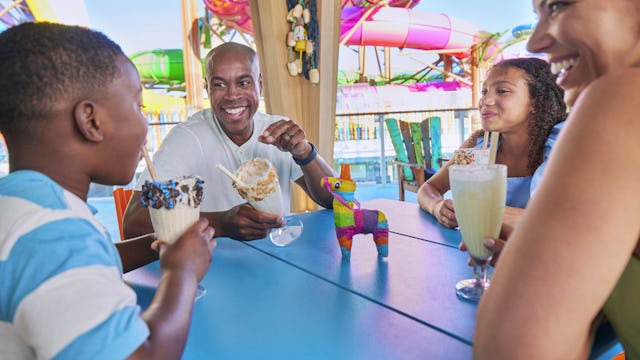 Family enjoying milkshakes at Basecamp onboard Icon of the Seas, sweets, relaxing, fun.