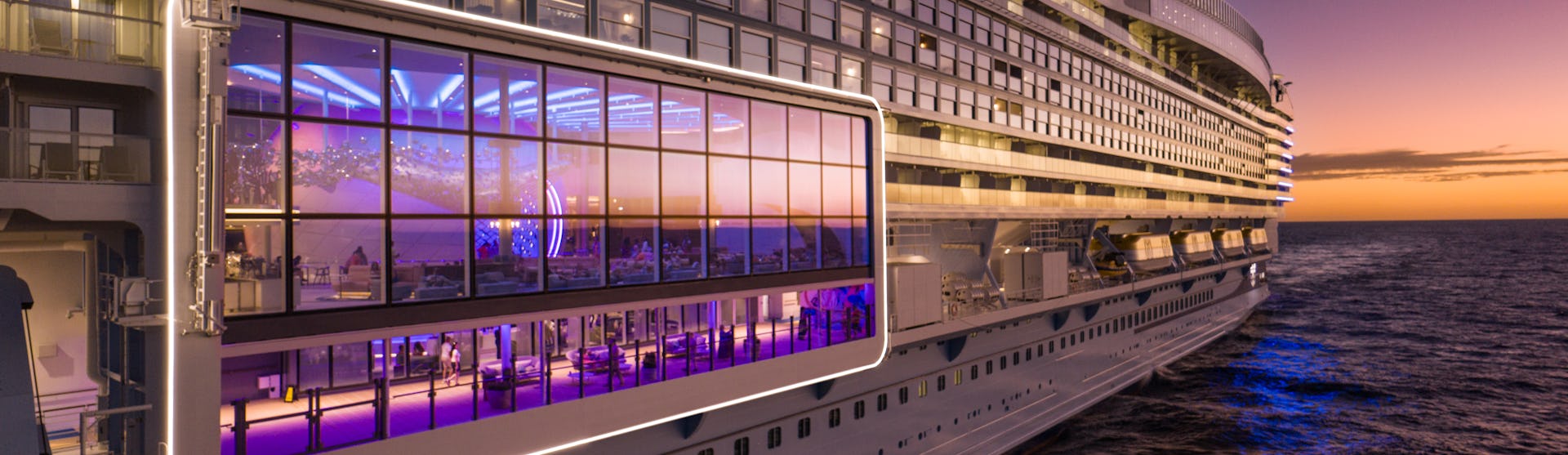 IC, Icon of the Seas, aerials, close-up of port side of ship at angle, view into Pearl Café, perspective, POV looking toward aft, sunset, evening, dusk, orange colors.