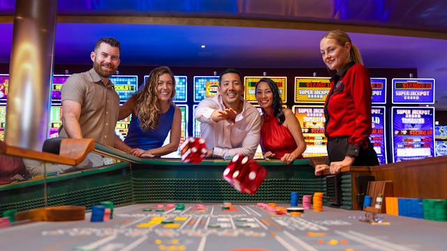 IC, Icon of the Seas, casino, group of players throwing dice at table in Casino Royale, attendant at side, fun, excitement, action, nightlife, games, craps,