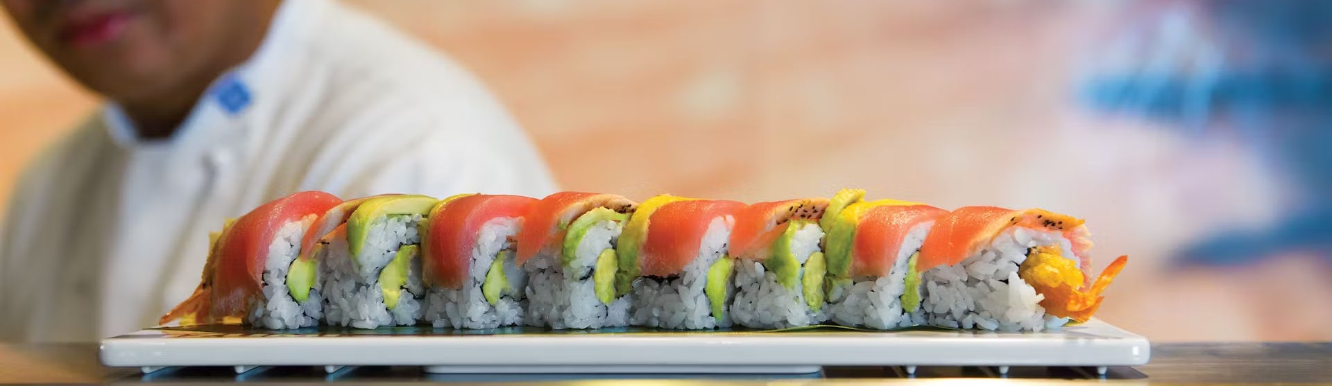 A sushi chef and a plate of sushi rolls at one of the many restaurants on board of Icon of the Seas.