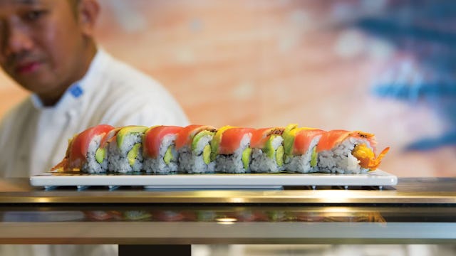 A sushi chef and a plate of sushi rolls at one of the many restaurants on board of Icon of the Seas.