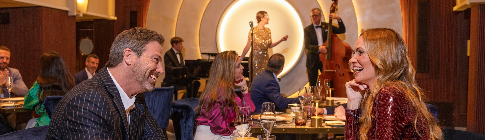 A couple having dinner at the Empire Supper Club, on board of the Icon of the Seas