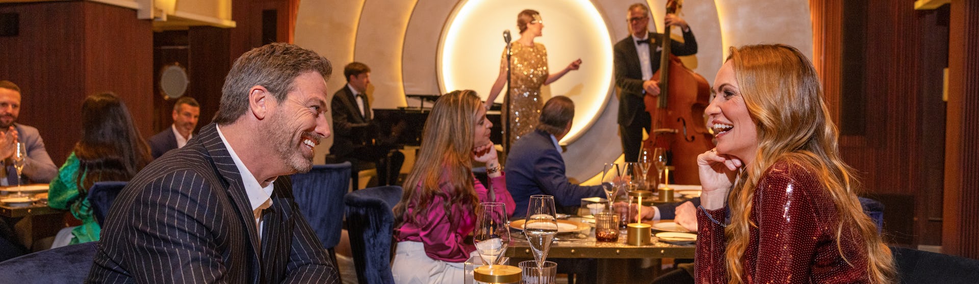 A couple having dinner at the Empire Supper Club, on board of the Icon of the Seas