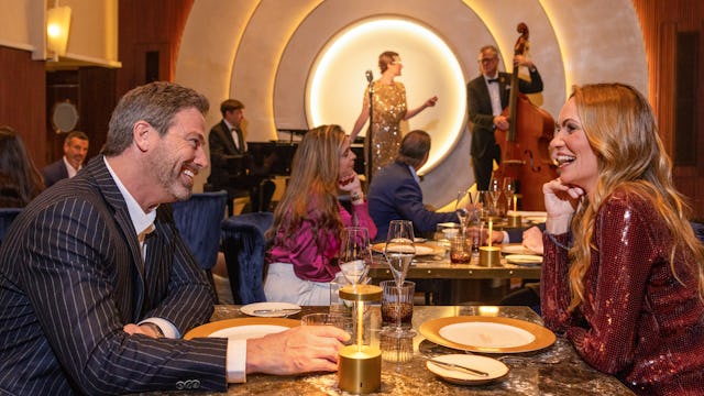 A couple having dinner at the Empire Supper Club, on board of the Icon of the Seas.