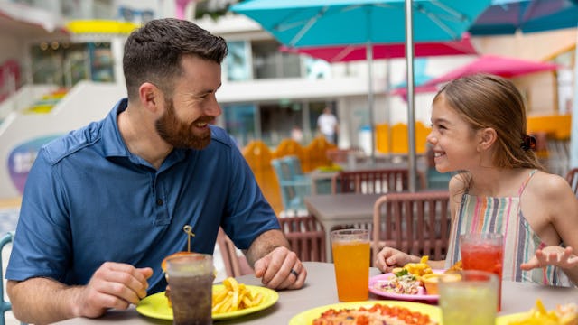 Family having a great time and enjoying some food at Surfside on board of Icon of the Seas.