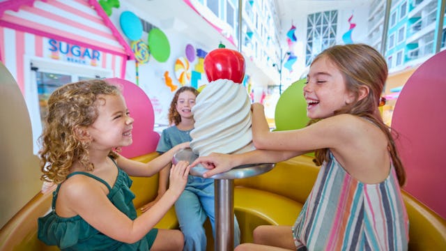 Children enjoying Surfside Carousel on board of the Icon of the Seas.