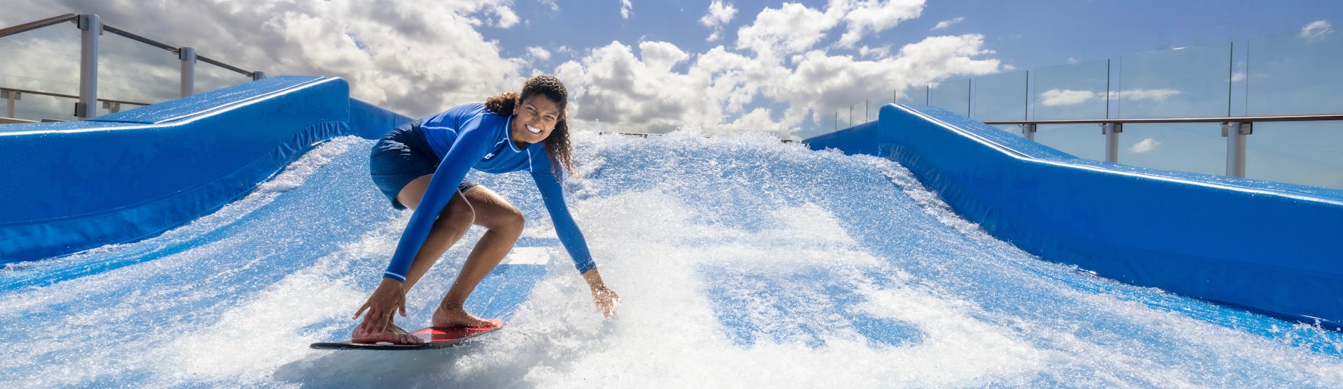Surfing at the FlowRider® surfing simulator on Icon of the Seas.