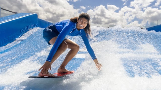 Surfing at the FlowRider® surfing simulator on Icon of the Seas.