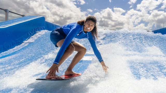 Surfing at the FlowRider® surfing simulator on Icon of the Seas.